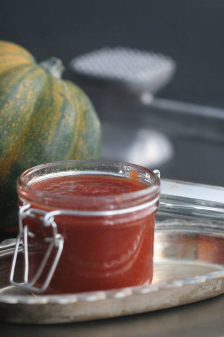 a jar of three tomato jam and an acorn squash