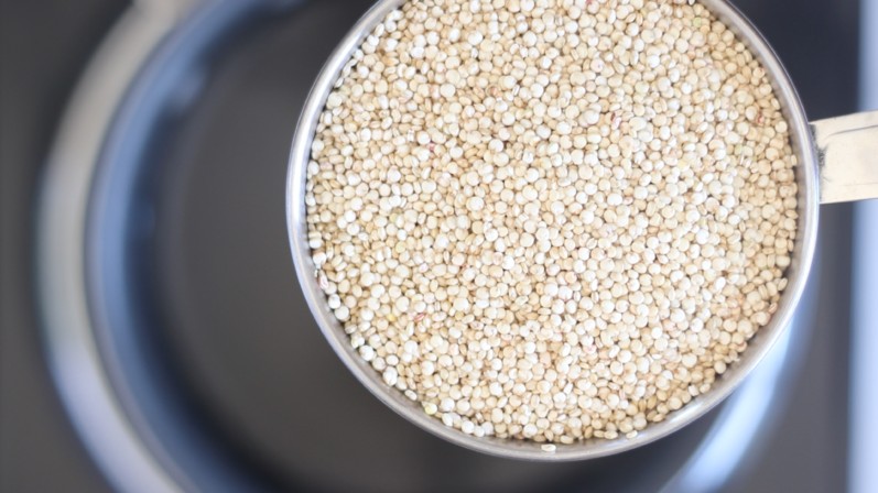 raw quinoa in a measuring cup 