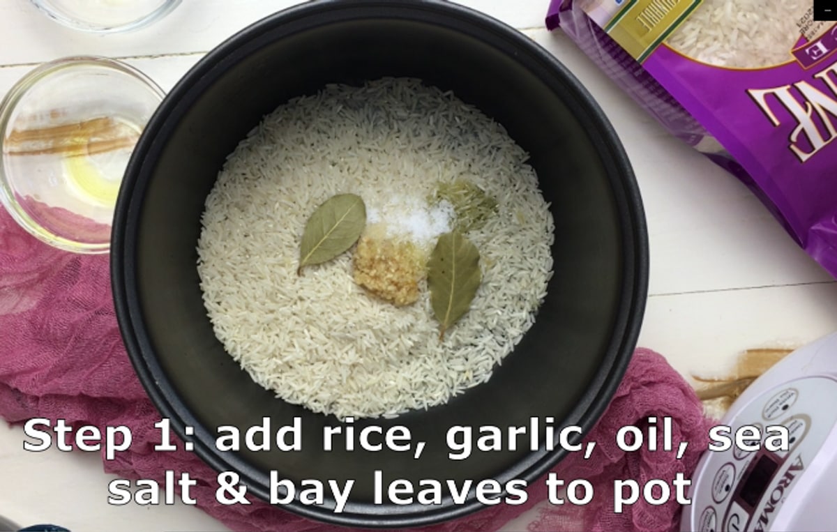 rice cooker with ingredients added for cilantro lime rice