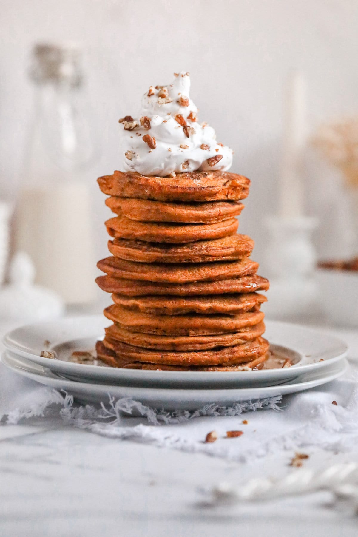 stack of whole wheat pumpkin pancakes without syrup on a white plate